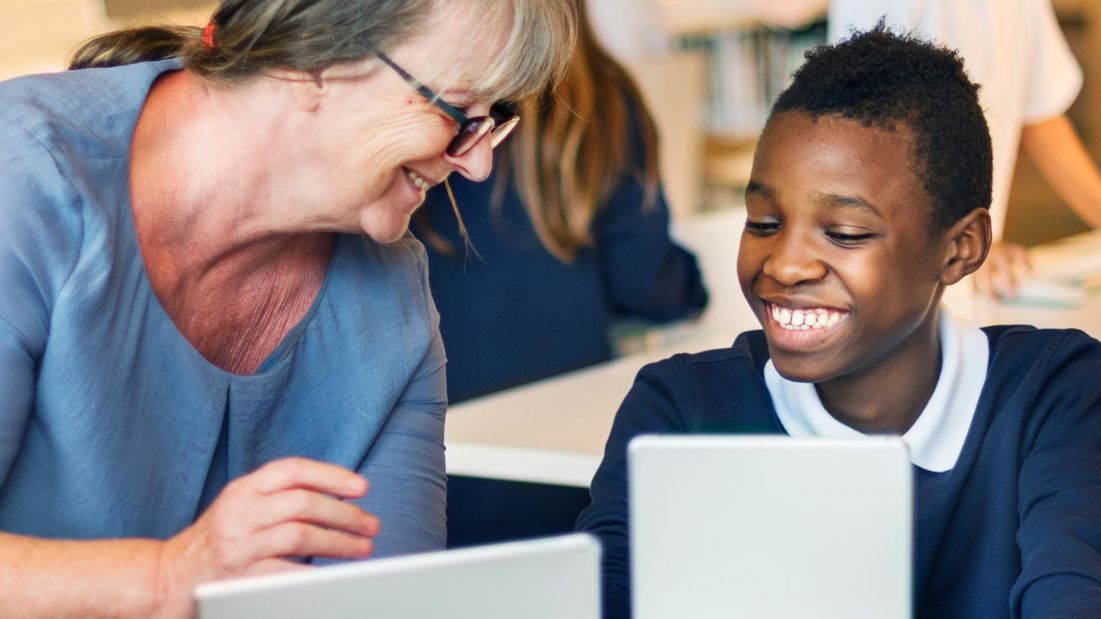 A boy using a tablet in a class room